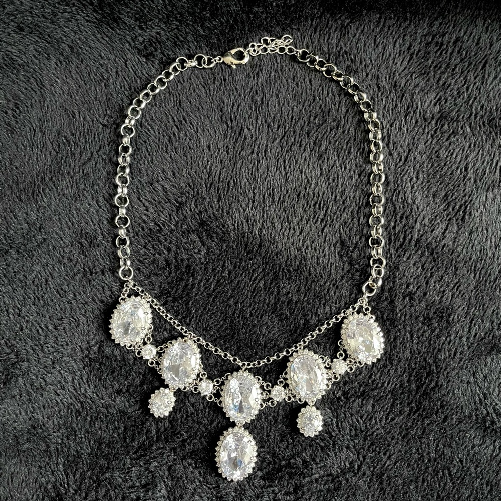 Silver jeweled statement necklace. 19” can be adjusted to 22”.